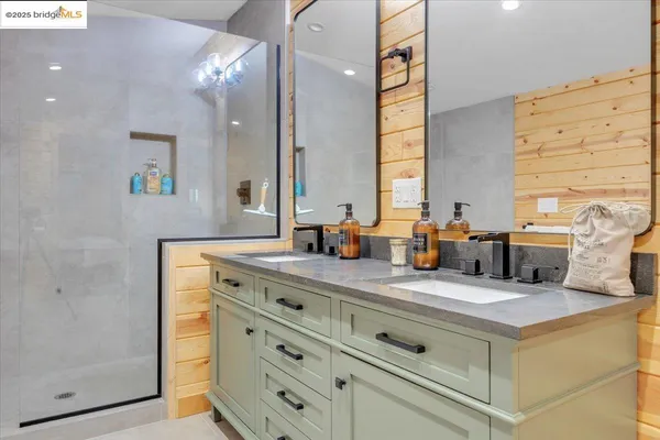 a bathroom with a sink double vanity and a mirror