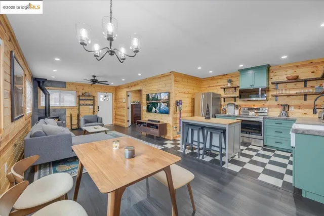 a large kitchen with a table and chairs in it