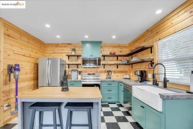 a kitchen with stainless steel appliances granite countertop a sink and cabinets