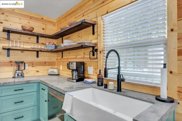 a kitchen with a stove a sink and a refrigerator
