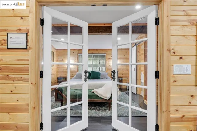 a bedroom with a bed table and window