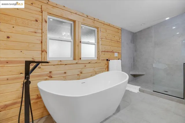 a spacious bathroom with a double vanity sink a mirror and a shower