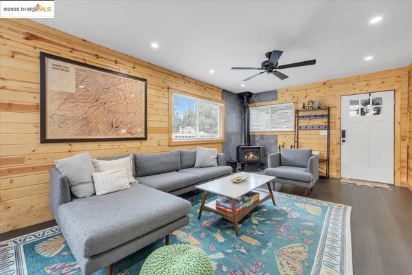 a living room with furniture a large window and a rug