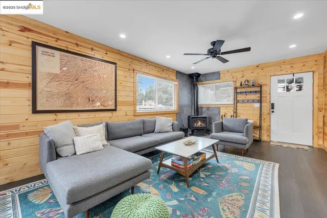 a living room with furniture a large window and a rug