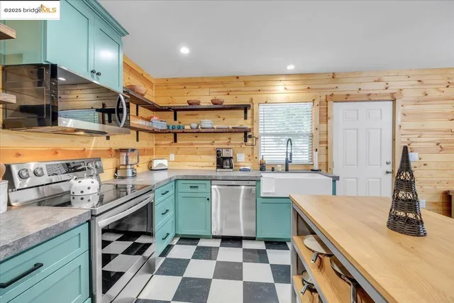a kitchen with a sink a stove and cabinets