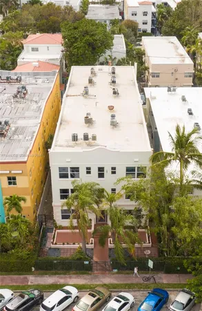 an aerial view of residential houses with yard