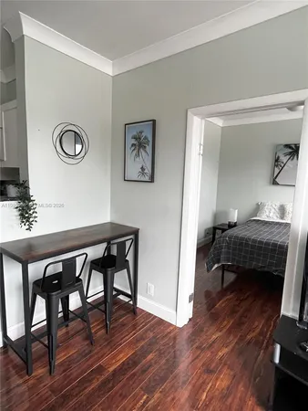 a bedroom with furniture and a wooden floor
