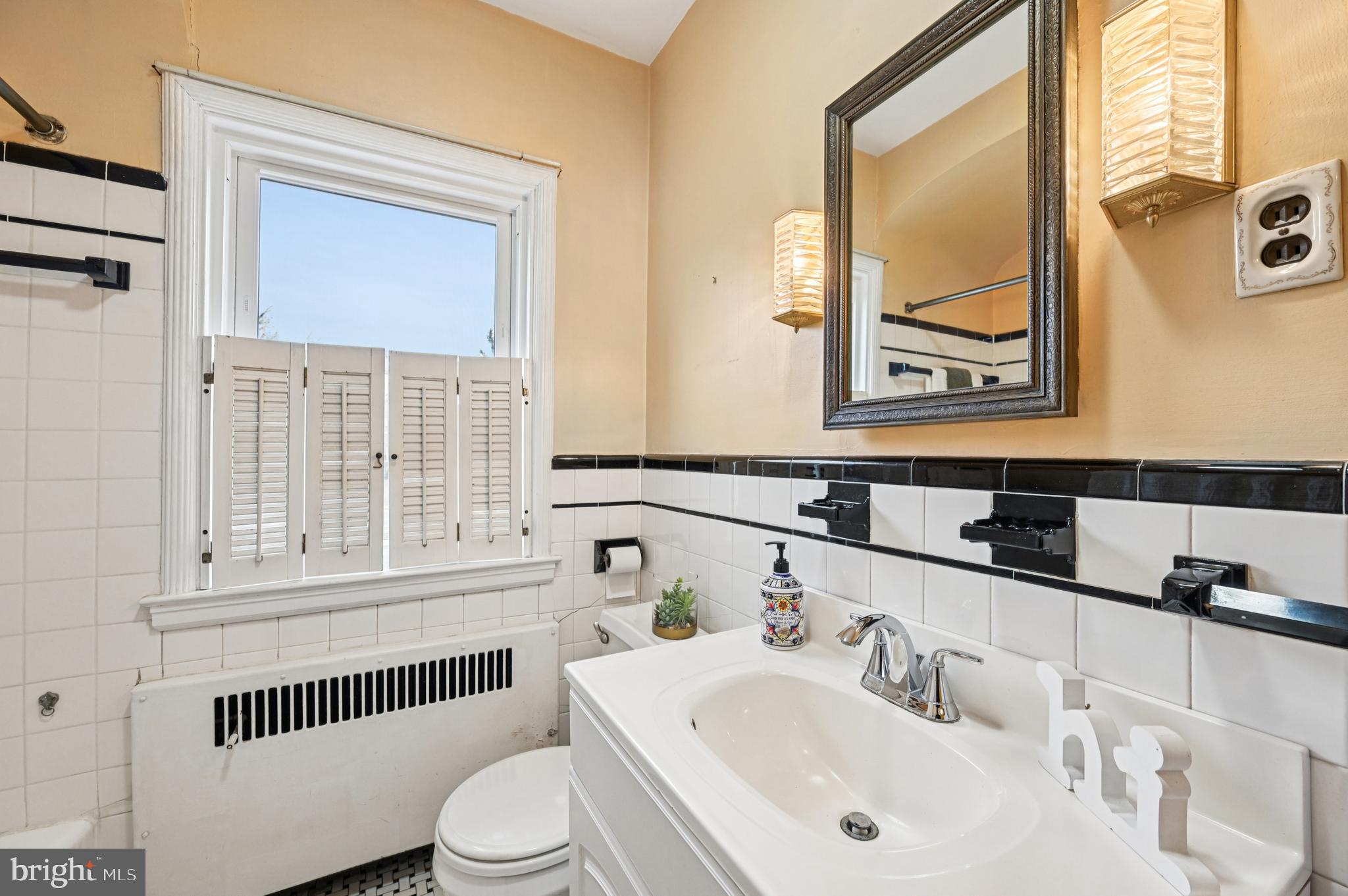 19 Somerset Road Baltimore, MD 21228 - Photo 12 of 39 a bathroom with a sink and a mirror