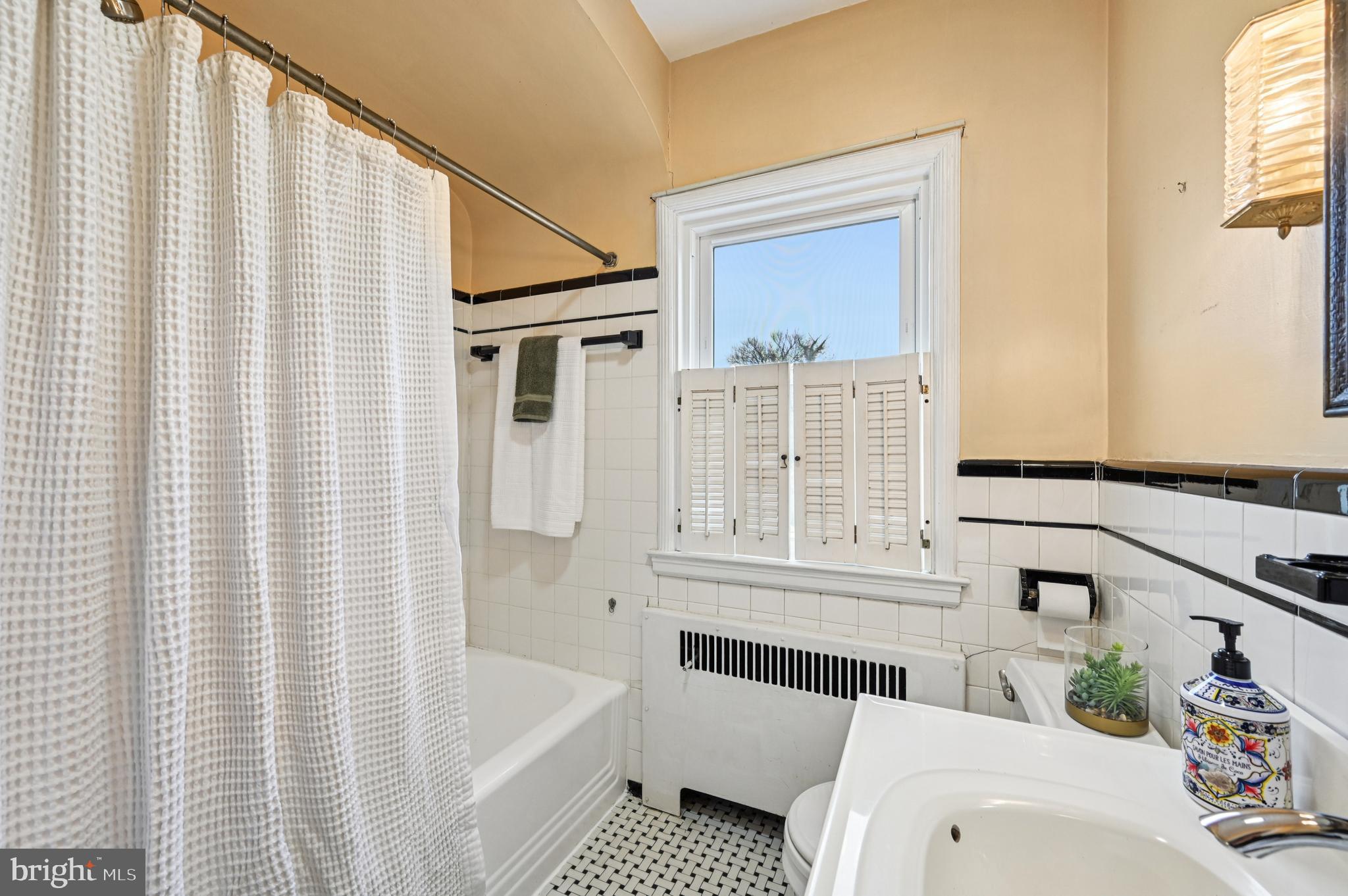 19 Somerset Road Baltimore, MD 21228 - Photo 13 of 39 a bathroom with a sink a bathtub and a shower