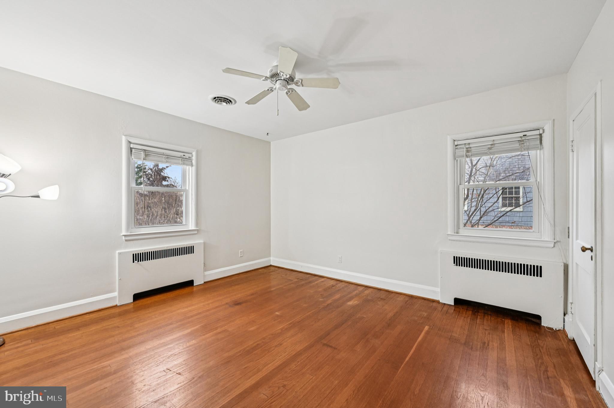 19 Somerset Road Baltimore, MD 21228 - Photo 18 of 39 a view of an empty room with wooden floor and a window