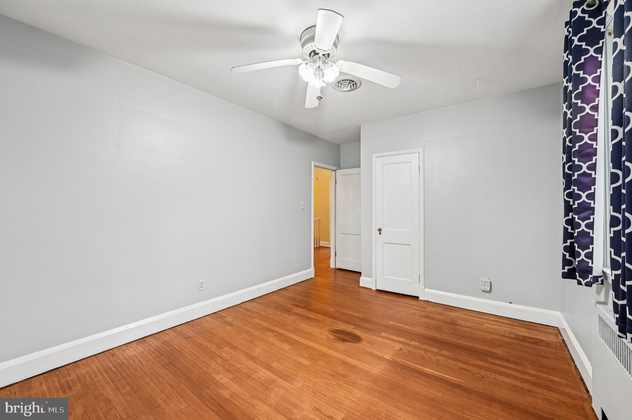 19 Somerset Road Baltimore, MD 21228 - Photo 19 of 39 a view of an empty room with wooden floor