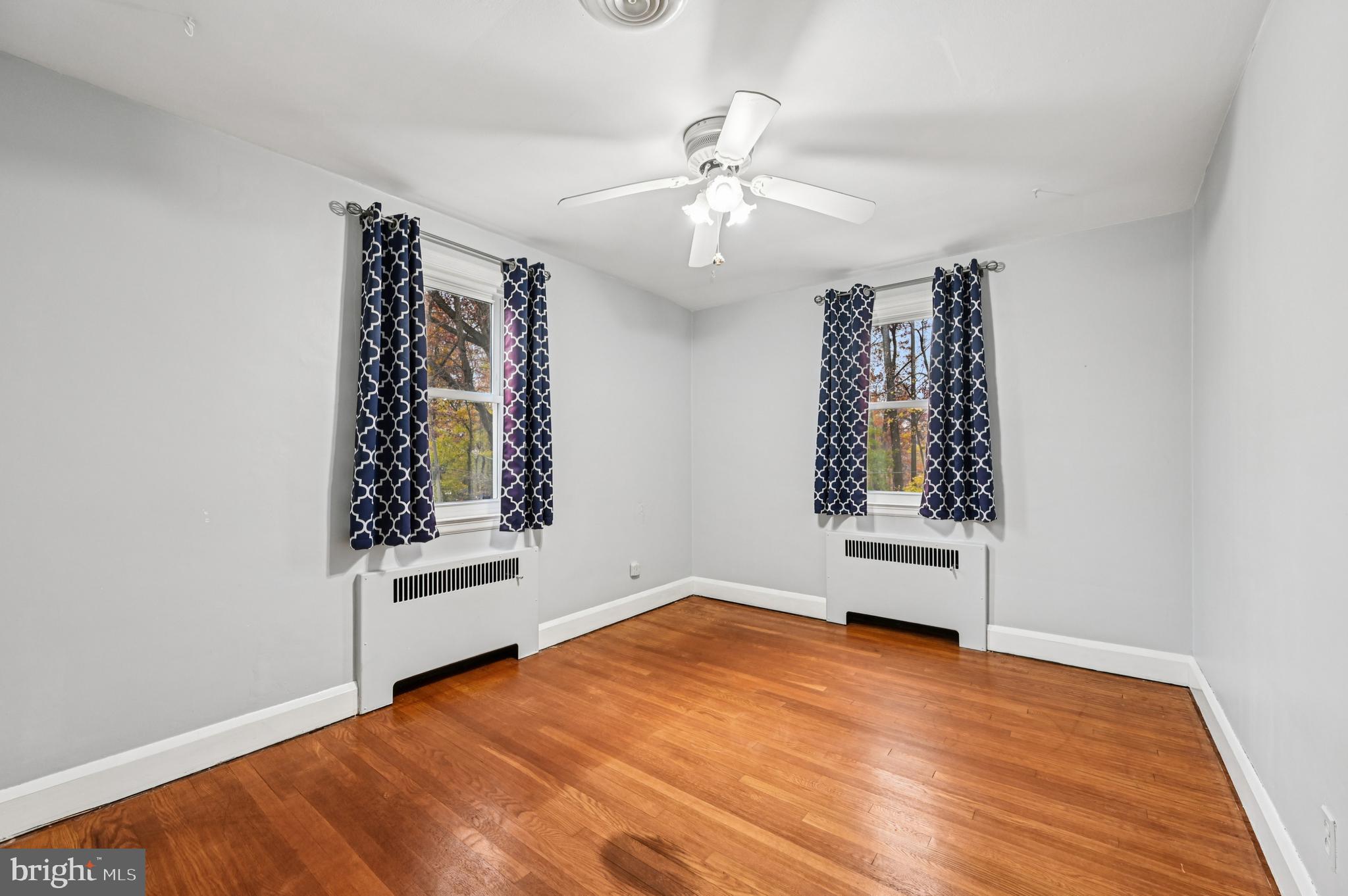 19 Somerset Road Baltimore, MD 21228 - Photo 20 of 39 wooden floor in an empty room with a window