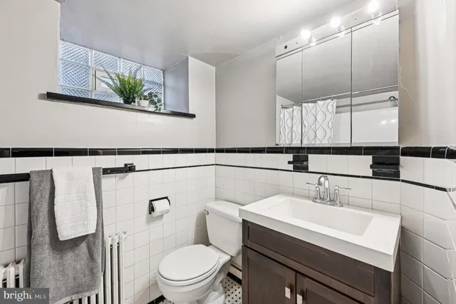 a view of empty room with wooden floor and cabinet