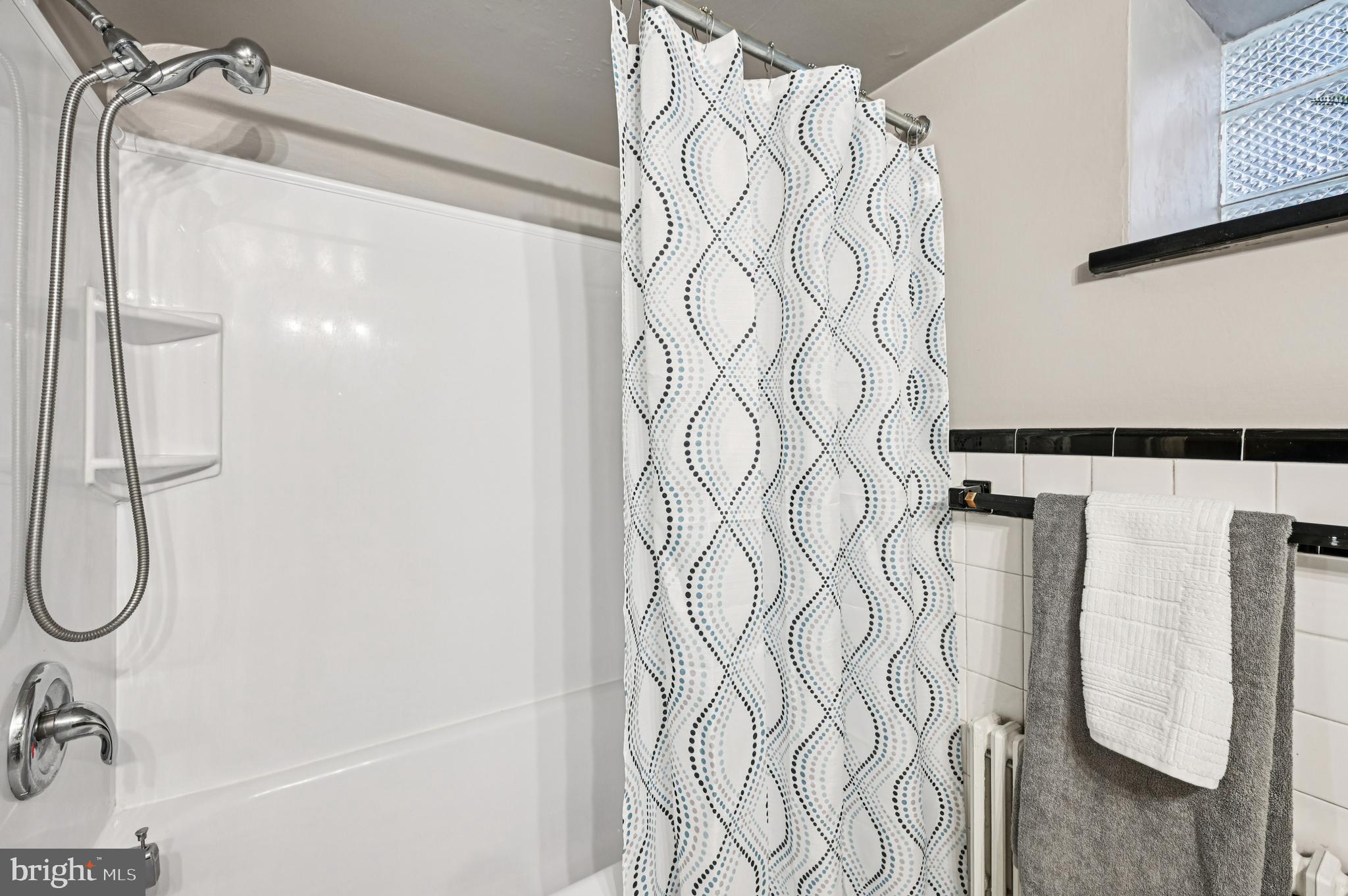 19 Somerset Road Baltimore, MD 21228 - Photo 32 of 39 a bathroom with a bathtub and shower