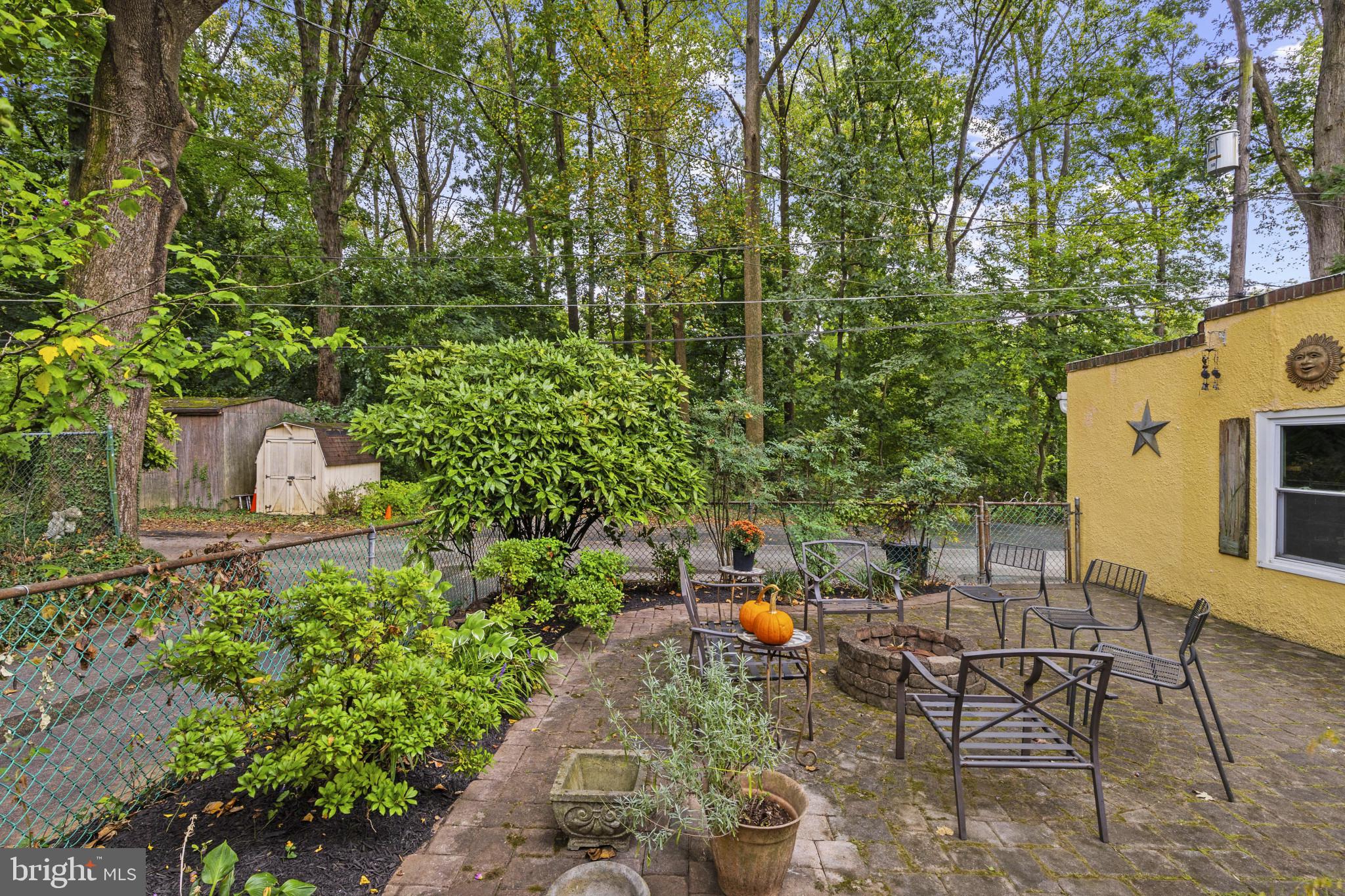 19 Somerset Road Baltimore, MD 21228 - Photo 35 of 39 a backyard of a house with table and chairs and potted plants