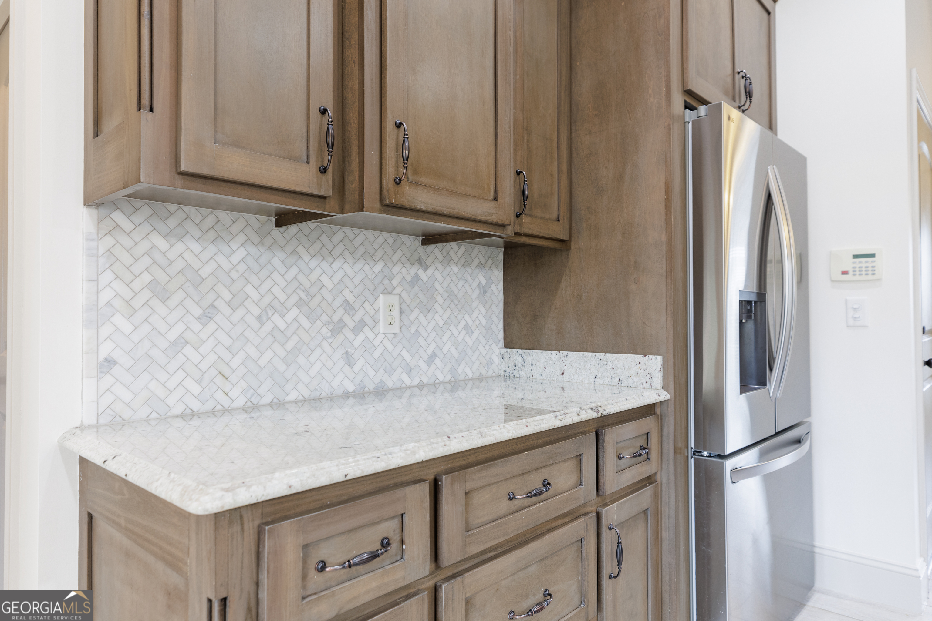 5109 Village Way Hahira, GA 31632 - Photo 15 of 42 a kitchen with granite countertop cabinets and refrigerator