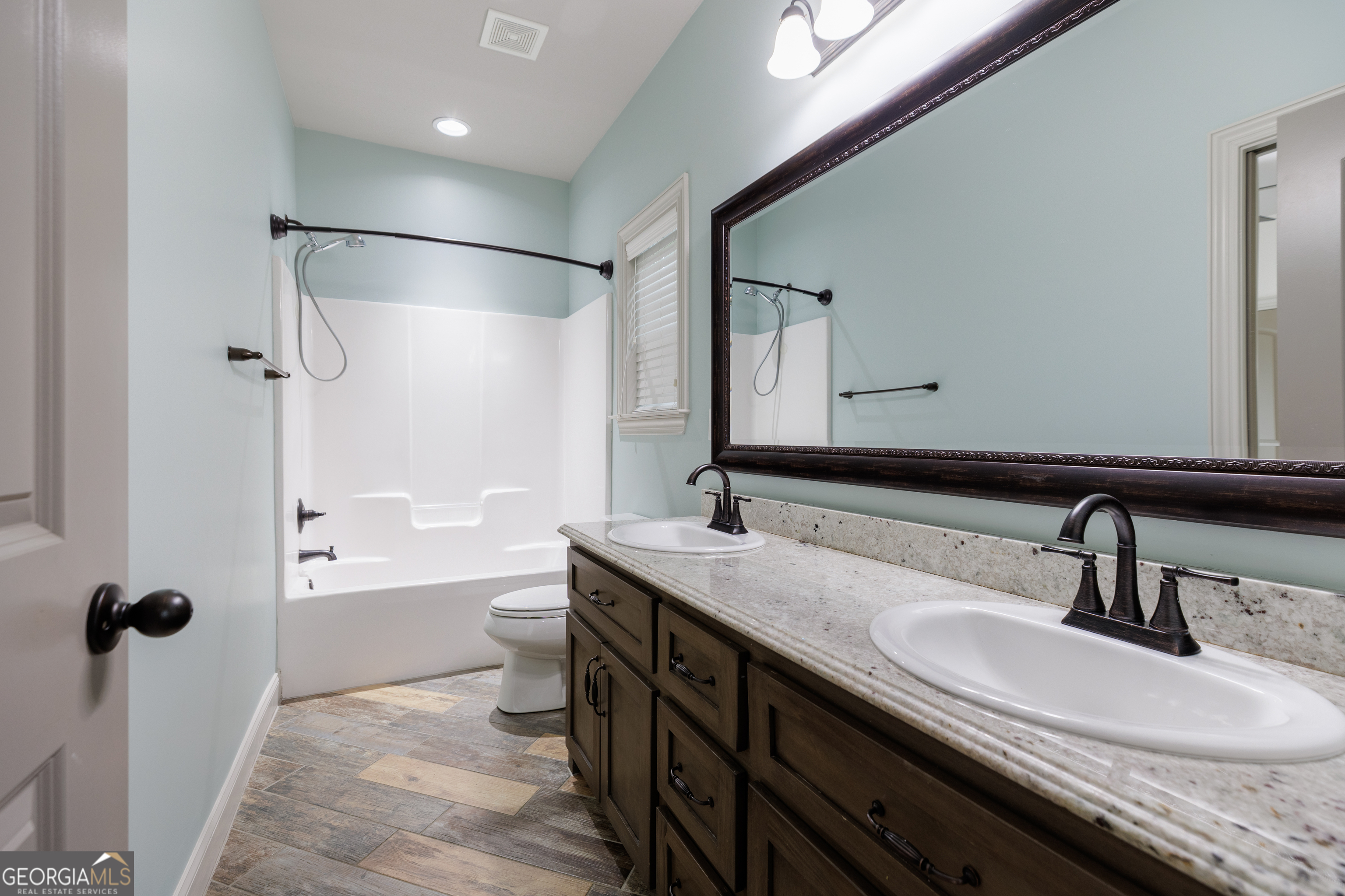 5109 Village Way Hahira, GA 31632 - Photo 33 of 42 a bathroom with a double vanity sink toilet mirror and shower