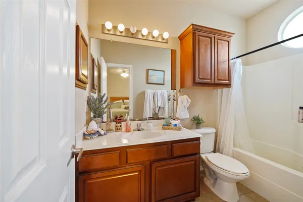 a bathroom with a sink a toilet and mirror