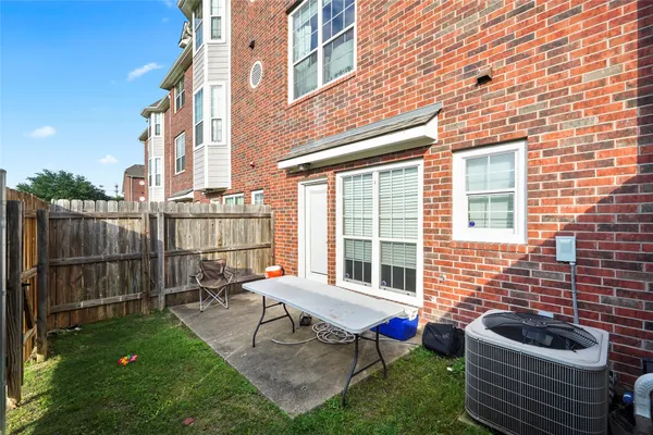 a backyard of a house with outdoor seating