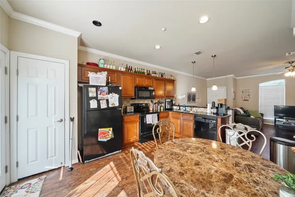 a kitchen with stainless steel appliances kitchen island granite countertop a refrigerator and stove