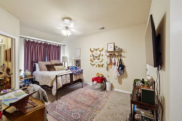 a bedroom with furniture and a flat screen tv