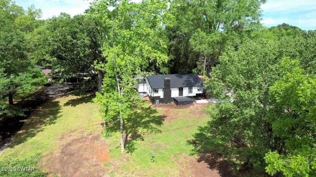 a backyard of a house with a yard and outdoor seating