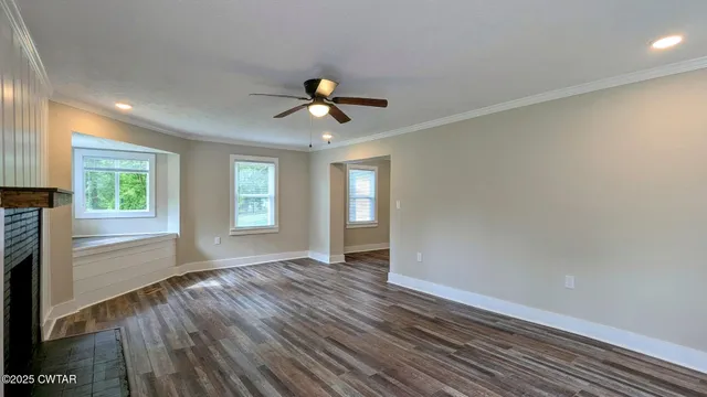 wooden floor in an empty room with a window