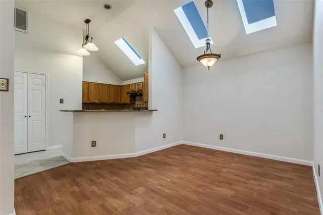 a view of a kitchen with microwave and cabinets