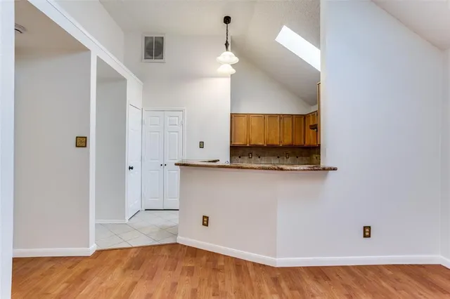a view of a livingroom with wooden floor and a ceiling fan