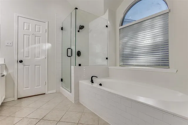 a bathroom with a bathtub and shower