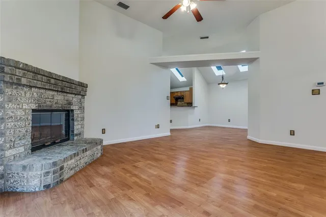 an empty room with fan and fireplace