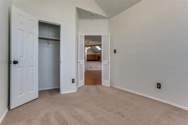 an empty room with closet and mirror