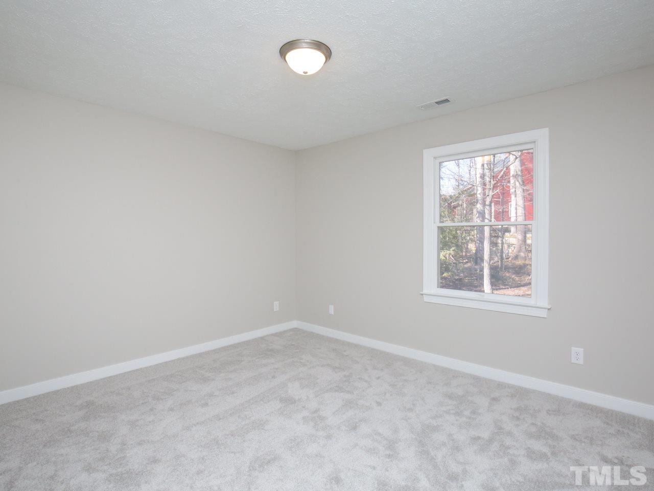 113 Trinity Woods Drive Raleigh, NC 27607 - Photo 22 of 27 an empty room with a window
