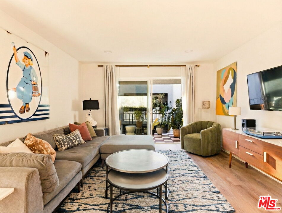 3015 Division Street, Unit 219 Los Angeles, CA 90065 - Photo 3 of 23 a living room with furniture and a flat screen tv