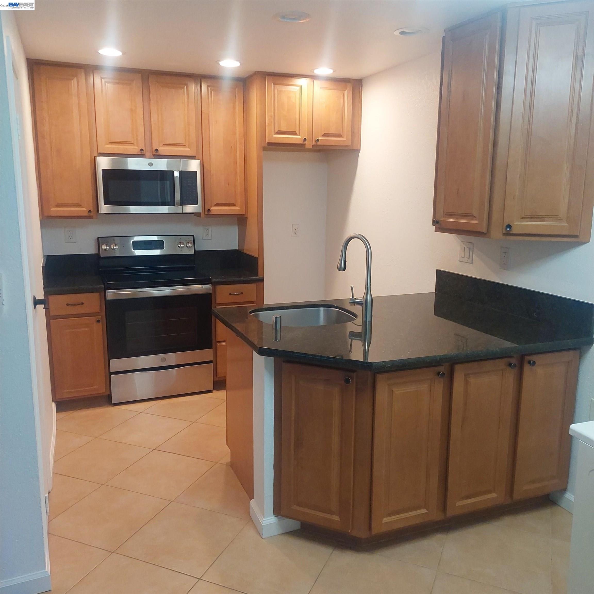 1544 Bailey Road, Unit 3 Concord, CA 94521 - Photo 2 of 10 a kitchen with stainless steel appliances granite countertop a sink stove and microwave