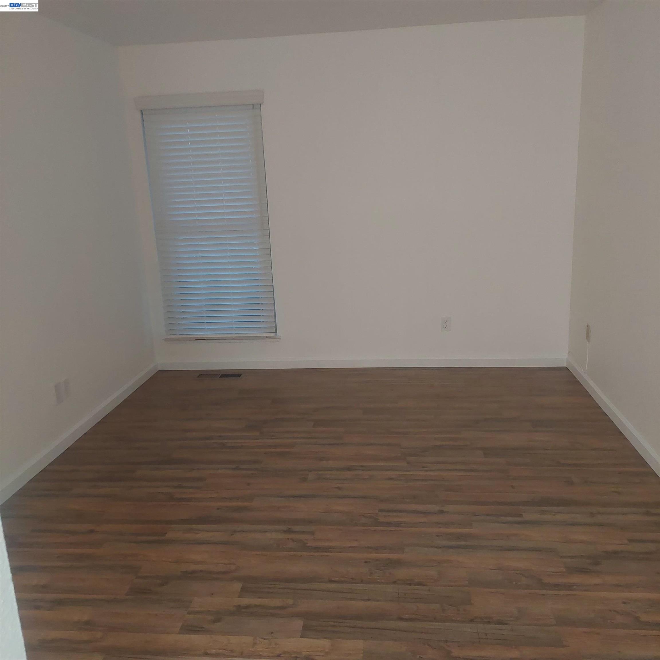 1544 Bailey Road, Unit 3 Concord, CA 94521 - Photo 8 of 10 a view of an empty room with wooden floor