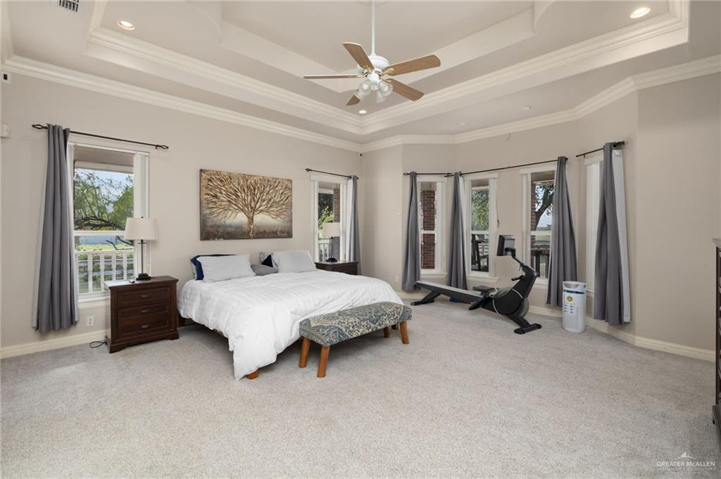 23725 North Val Verde Road Edinburg, TX 78542 - Photo 17 of 36 a spacious bedroom with a bed and a chandelier