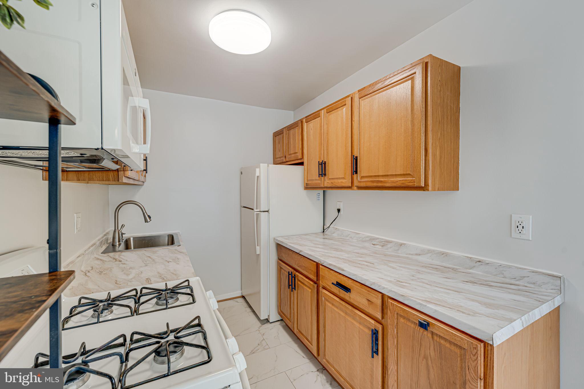 1200 South Arlington Ridge Road, Unit 714 Arlington, VA 22202 - Photo 11 of 24 a kitchen with stainless steel appliances granite countertop a sink stove and cabinets