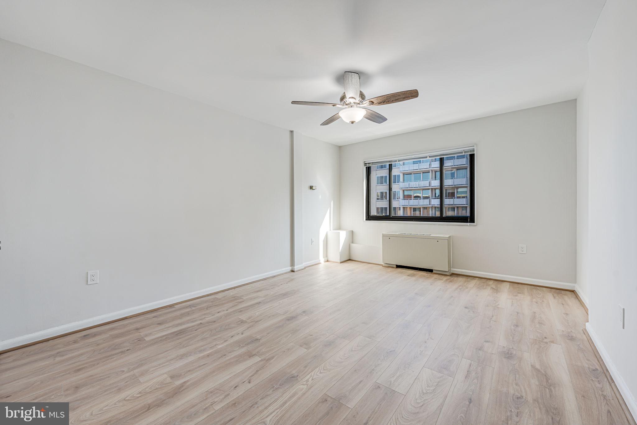 1200 South Arlington Ridge Road, Unit 714 Arlington, VA 22202 - Photo 13 of 24 wooden floor in an empty room with a window