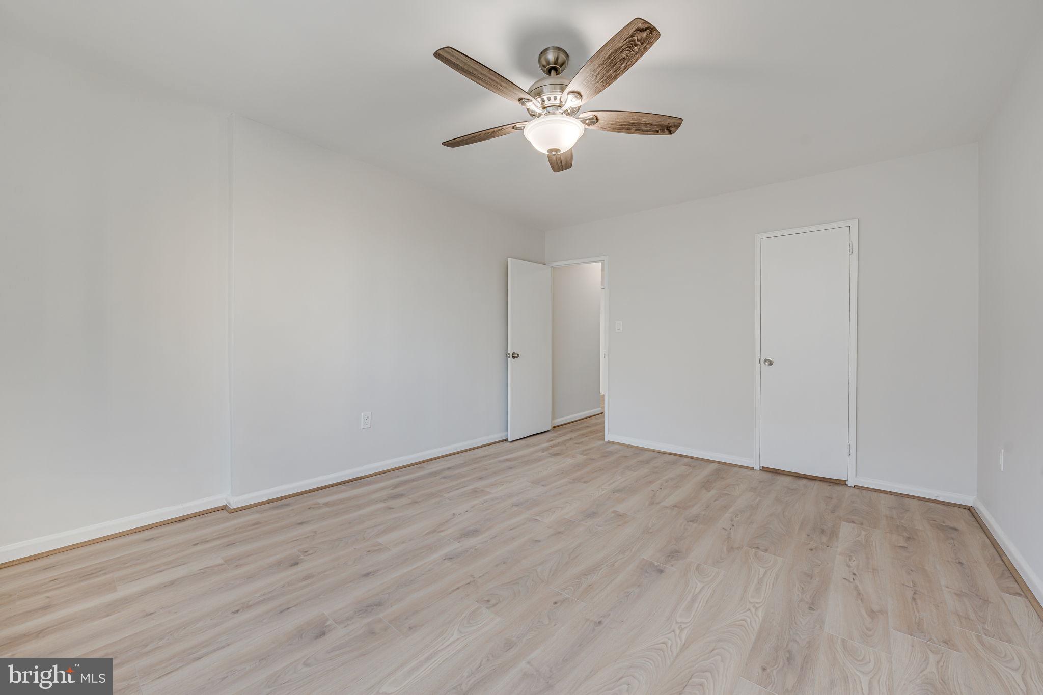 1200 South Arlington Ridge Road, Unit 714 Arlington, VA 22202 - Photo 15 of 24 an empty room with wooden floor and ceiling fan