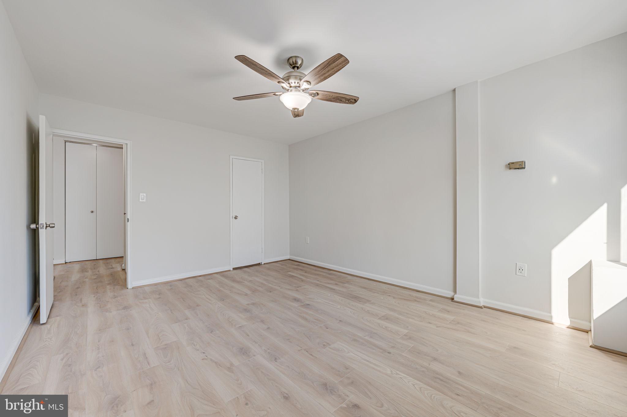 1200 South Arlington Ridge Road, Unit 714 Arlington, VA 22202 - Photo 16 of 24 a view of an empty room with wooden floor and a ceiling fan