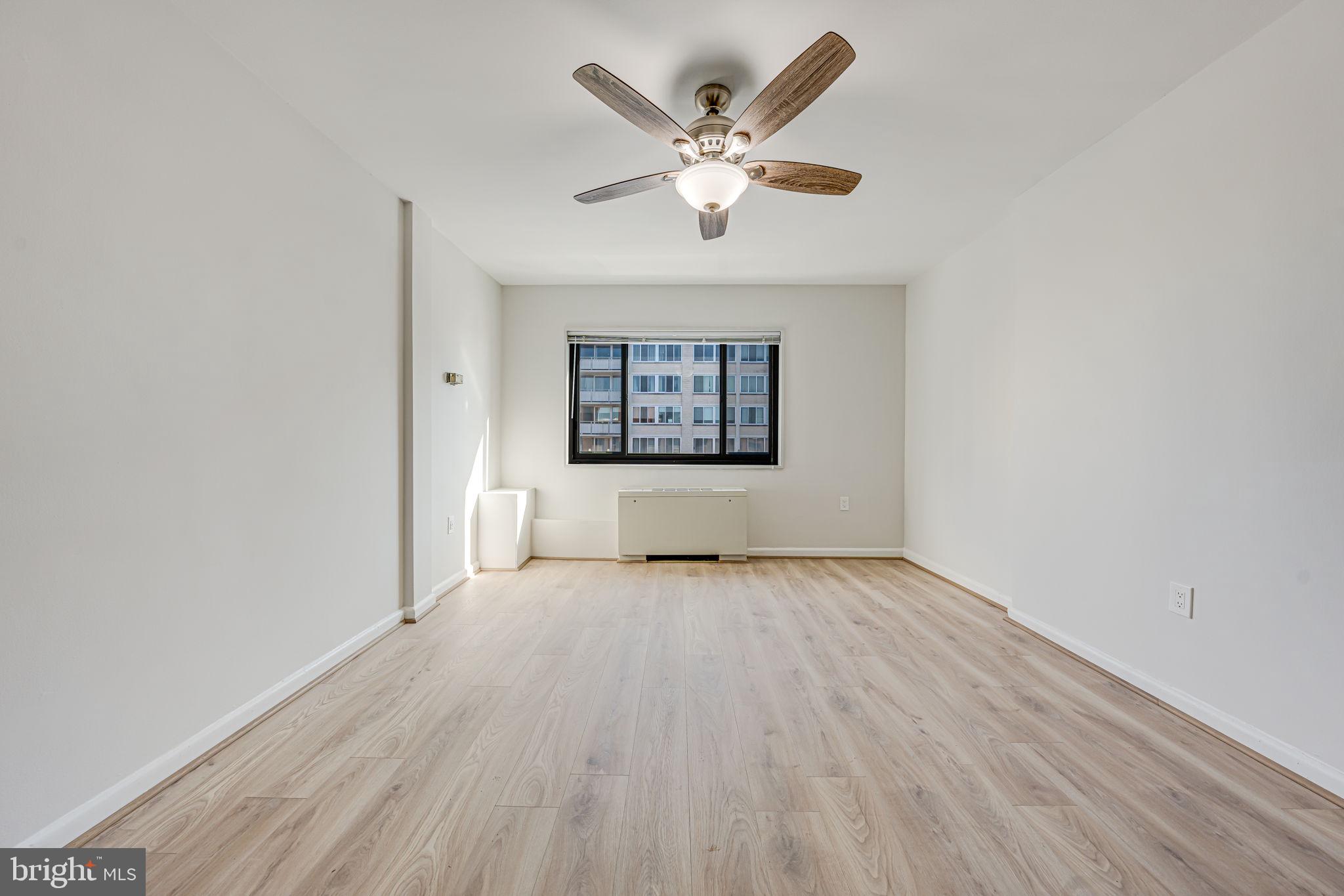 1200 South Arlington Ridge Road, Unit 714 Arlington, VA 22202 - Photo 17 of 24 an empty room with wooden floor and windows