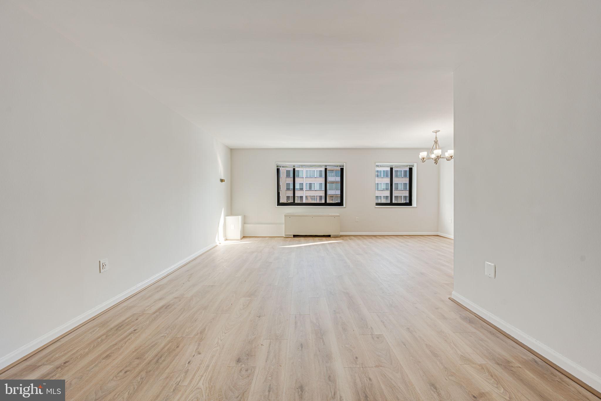 1200 South Arlington Ridge Road, Unit 714 Arlington, VA 22202 - Photo 18 of 24 an empty room with wooden floor and windows