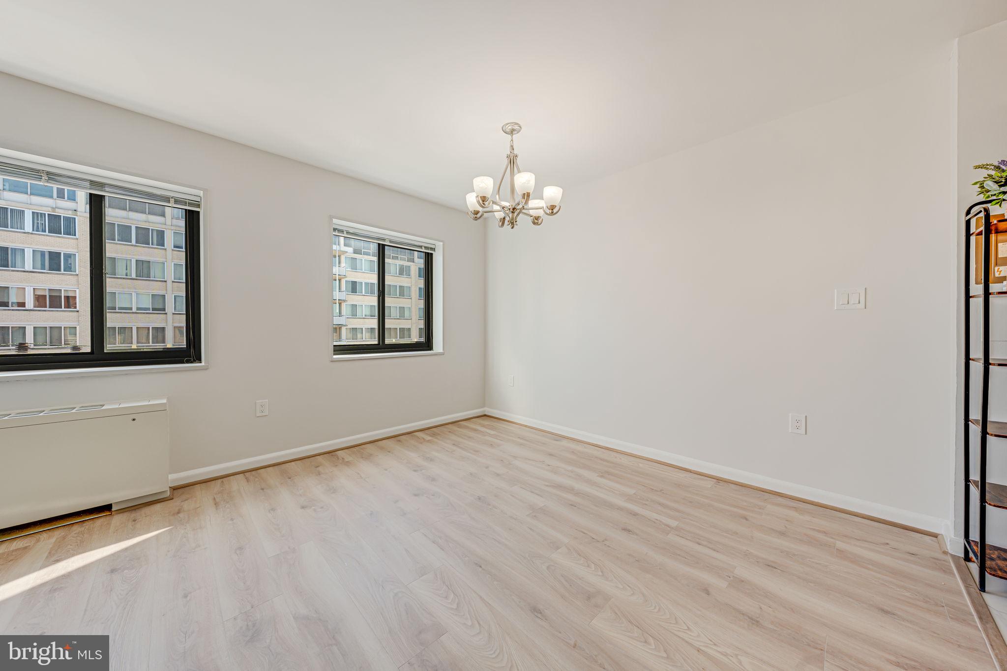 1200 South Arlington Ridge Road, Unit 714 Arlington, VA 22202 - Photo 20 of 24 a view of an empty room with a window and wooden floor