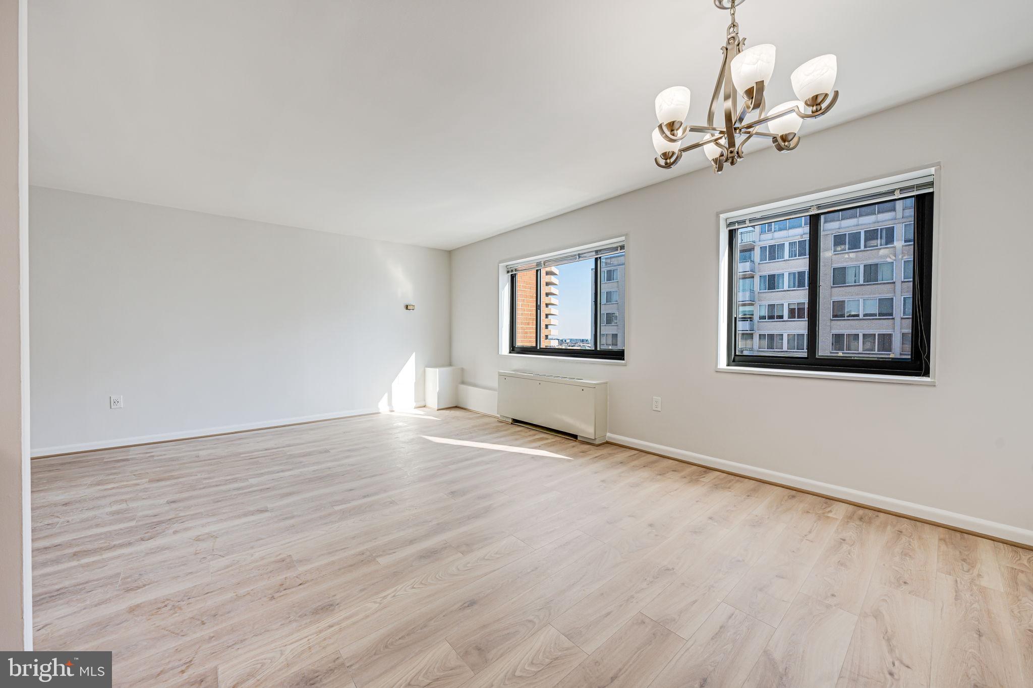 1200 South Arlington Ridge Road, Unit 714 Arlington, VA 22202 - Photo 8 of 24 a view of an empty room with wooden floor and a window