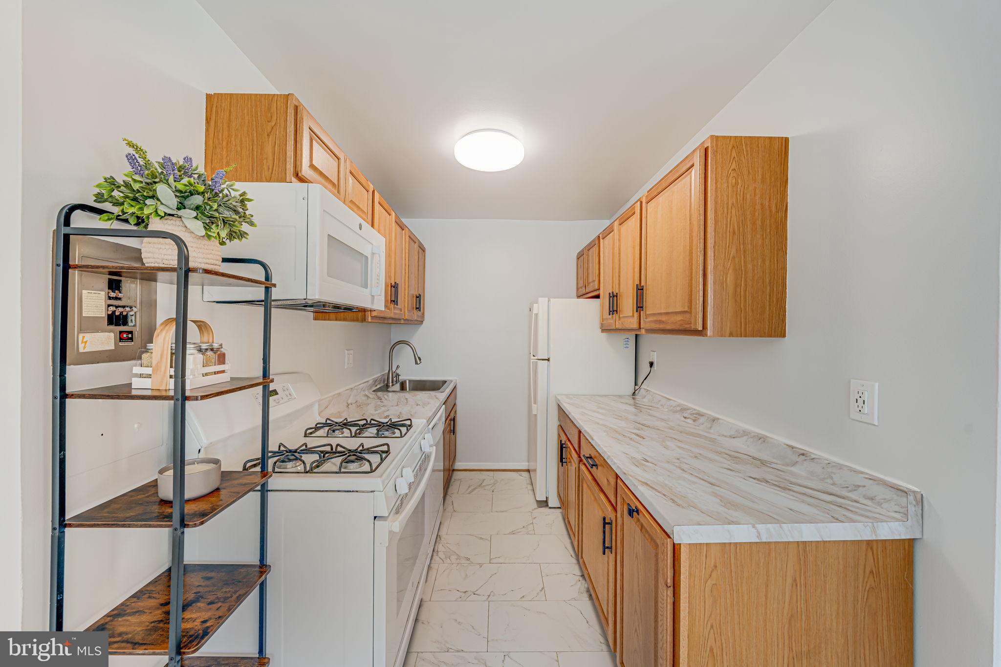 1200 South Arlington Ridge Road, Unit 714 Arlington, VA 22202 - Photo 9 of 24 a kitchen with stainless steel appliances granite countertop a stove a sink and a refrigerator