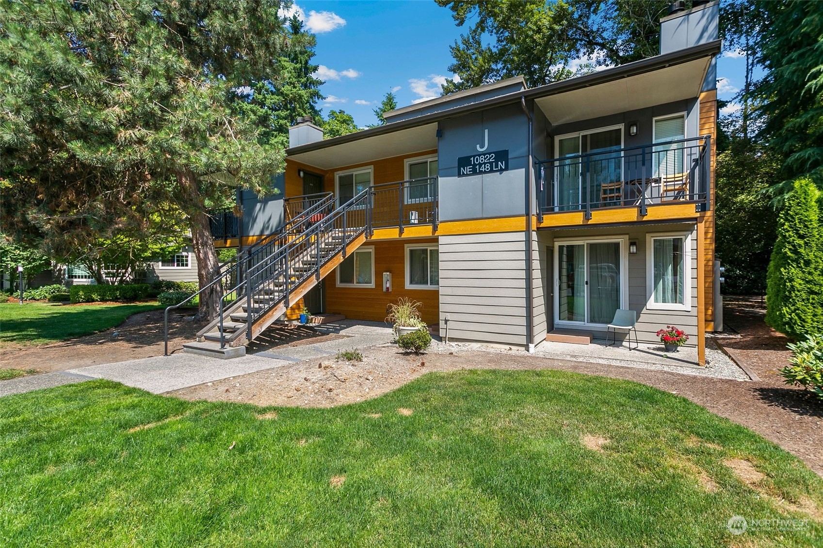 10822 Northeast 148th Lane, Unit J101 Bothell, WA 98011 - Photo 1 of 22 a view of a house with a yard and sitting area