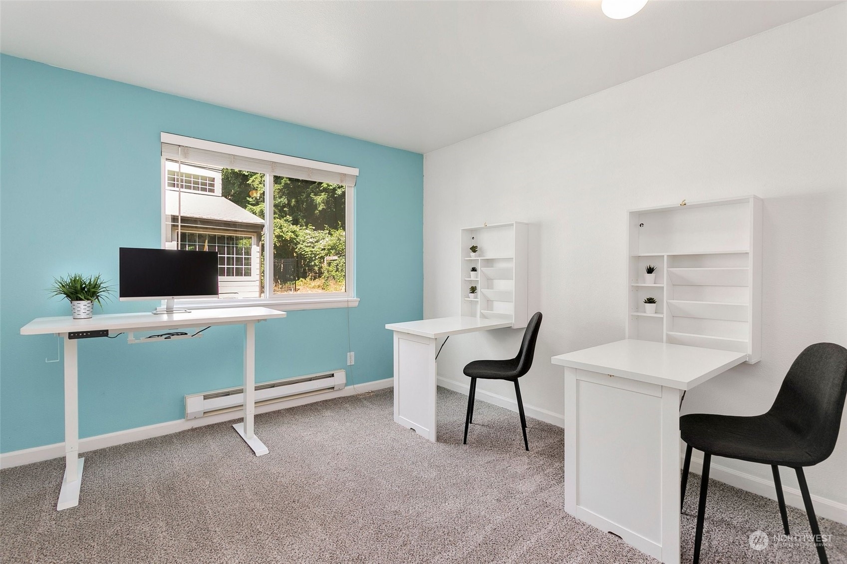 10822 Northeast 148th Lane, Unit J101 Bothell, WA 98011 - Photo 13 of 22 a view of a workspace with furniture and a window
