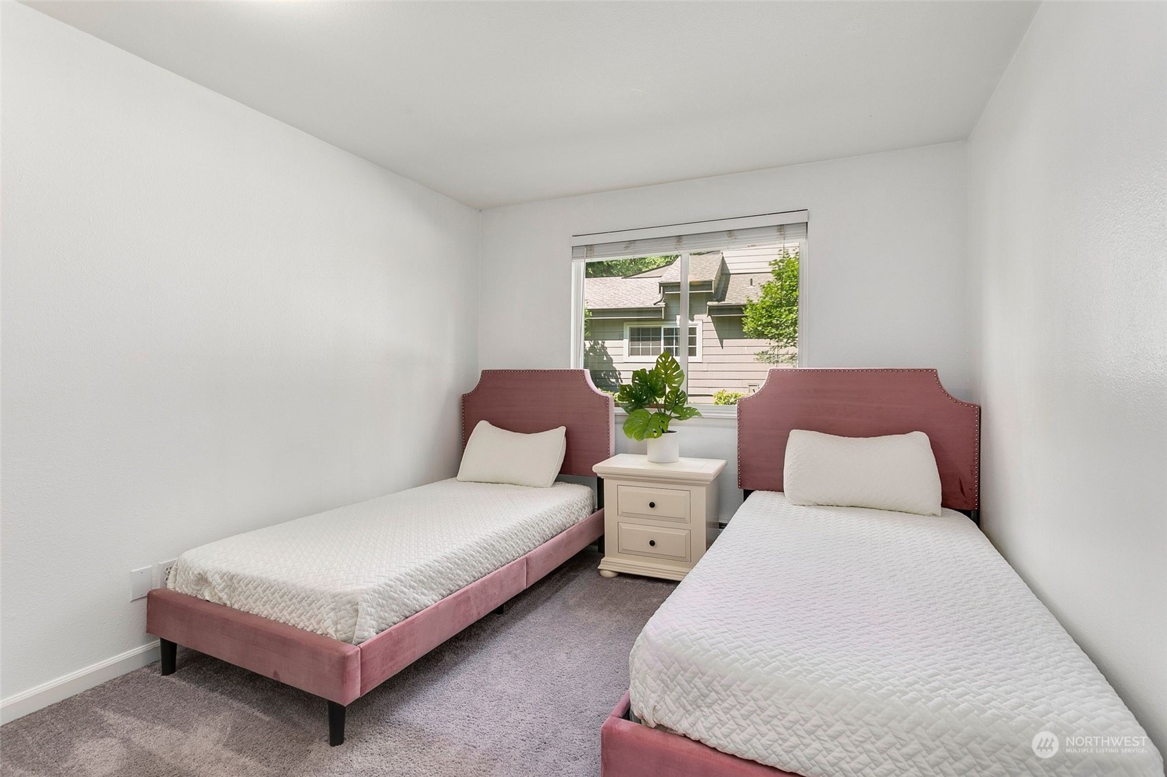 10822 Northeast 148th Lane, Unit J101 Bothell, WA 98011 - Photo 14 of 22 a bedroom with two beds lamp and a window
