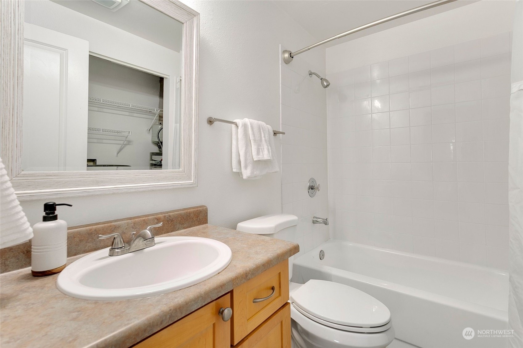10822 Northeast 148th Lane, Unit J101 Bothell, WA 98011 - Photo 15 of 22 a bathroom with a sink toilet tub and shower
